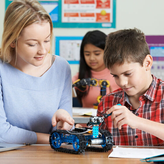 Teacher With Pupils In Science Lesson Studying Robotics